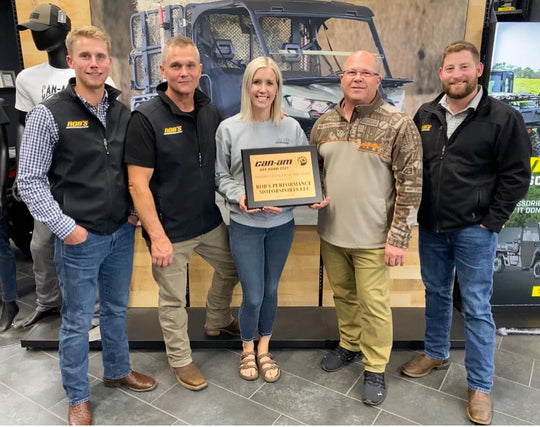 Picture of Morgan Struass, Taylor Struass, and Rob himself holding Can-Am dealer of the year award. 